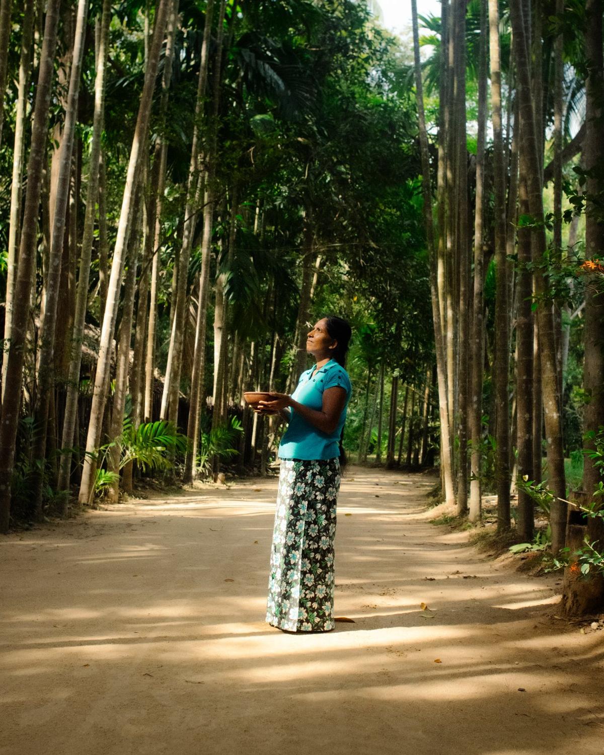 A villager along the jungle path surrounded by trees